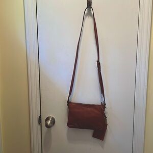 Cute leather cross body with card/key case. Zip pockets inside and outside.